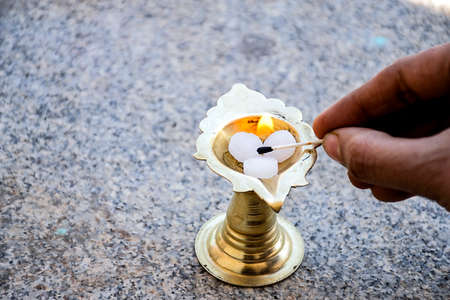 Stock photo of white camphor kept in camphor holder man lighting up camphor for presenting rituals...
