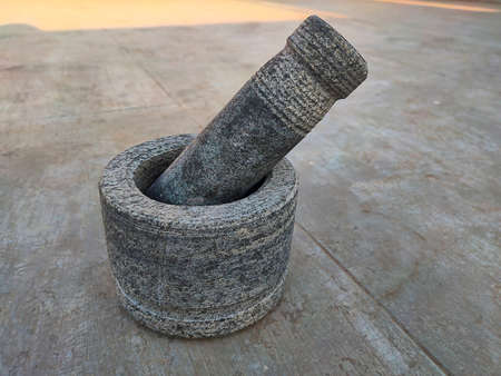 Stock photo beautiful traditional handmade round shape stone mortar and pestle on blur background. focus on object.の写真素材