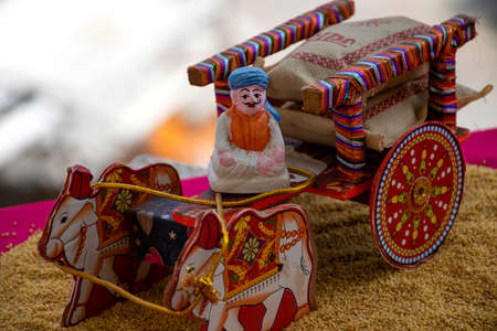 Stock photo of a beautiful traditional Indian wooden bull cart and statue of farmer sitting on bull...