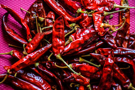 Stock photo of dry and hot red chillies on background texture. Picture captured under bright light at Bnaglore, Karnataka, India. organic food. selective focus.の写真素材