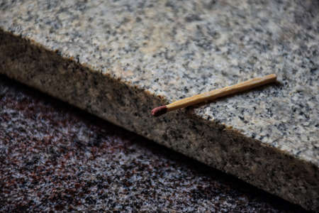 Stock photo of single matchstick kept on granite stone under natural light, Picture captured at Bangalore, Karnataka, India. focus on object.の写真素材