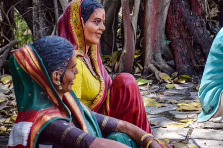 Kolhapur, India- March 16th 2019; Statue of Indian village women's wearing traditional cloths saree, bangles,necklaces sitting under tree and spending time with family members, at Kanheri math museumのeditorial素材