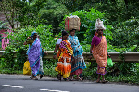 Kolhapur ,Maharashtra , India- September 15th 2019; group of Indian women carrying bag on head going...