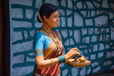 Kolhapur,India-March 16th 2020; Stock photo of 30 to 40 year old Indian women statue, wearing pink...