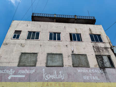 Gulbarga,India- October 13th 2021;Exterior view of two floor clothing shop's building in the whole sale market area at Gulbarga. blue sky on background. Picture captured under bright sunlight.のeditorial素材