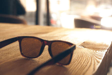 sunglasses on a wooden tableの写真素材