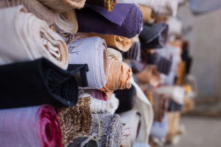 Fabric folded with rolls of different colors folded on top of each otherの写真素材