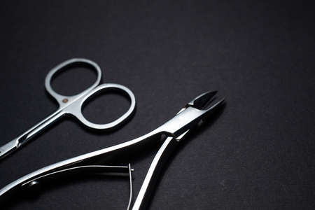 Manicure set of tools made of steel isolated on black background.の写真素材