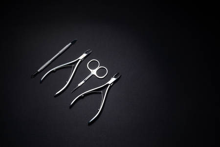 Manicure set of tools made of steel isolated on black background.の写真素材