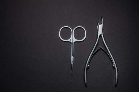 Manicure set of tools made of steel isolated on black background.の写真素材