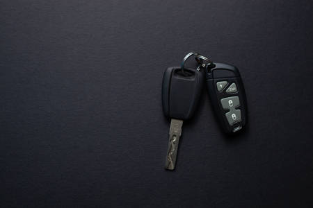Car keys with remote from car alarm on isolated black backgroundの写真素材