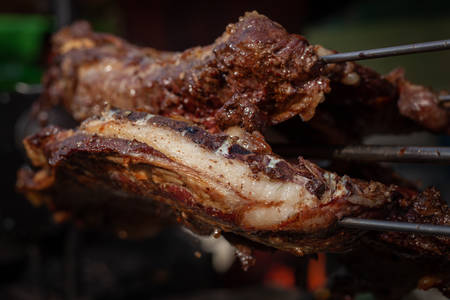 Marinated fried pork ribs cooked on a skewer over charcoalの写真素材