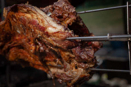 Marinated fried pork ribs cooked on a skewer over charcoalの写真素材