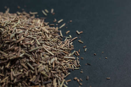 Spice caraway seeds sprinkled on a black backgroundの写真素材