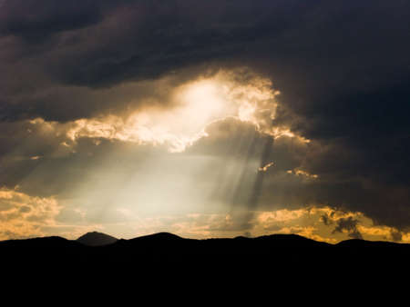 Sunbeams through storm cloudsの写真素材
