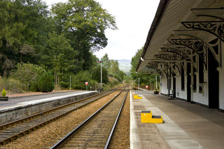 View of tracks and train station in Dunkled Scotlandの写真素材