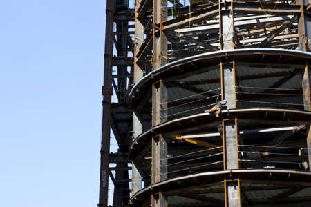 Metal worker welder on ledge of skyscraper structureの写真素材