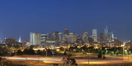Denver skyline at night. Summer 2010. Focus on skyscrapers. Automobile traffic lights in foregroundの写真素材
