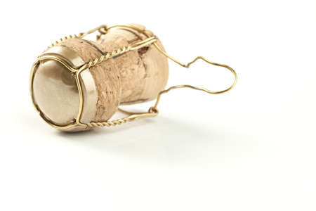 Champagne cork with metal wire isolated on white. Soft shadow. Studio shot. Focus on front edge of cork.の写真素材