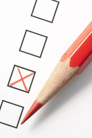 Red pencil next to survey check boxes and red x symbol. Focus on tip of pencil.の写真素材