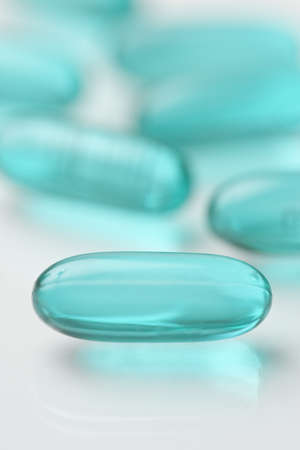 High key shot of white pills brightly lit.