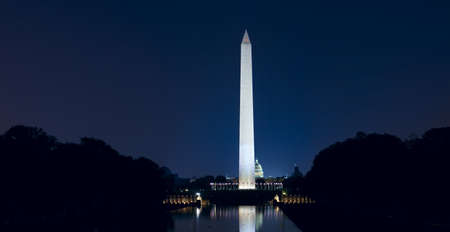 Washington Monument with US Capitol. Late night iew with glow of city lights.の写真素材