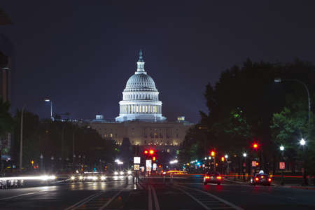 Capitol seen from Pennsylvania Avenue. Night time with traffic rushing by.の写真素材