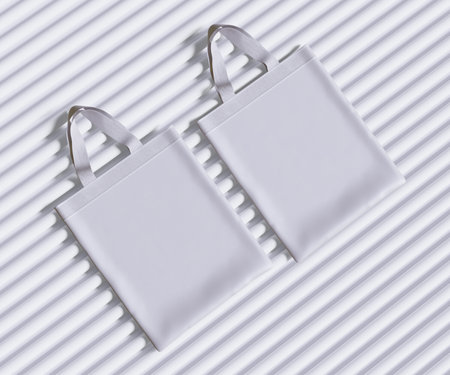 White shopping bag on striped background. Flat lay, top view.の写真素材