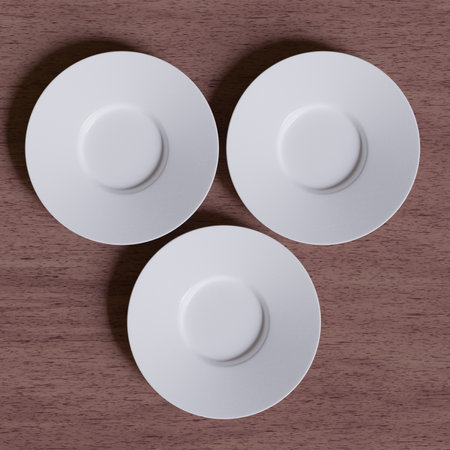 3d render of a set of white porcelain plates on wooden backgroundの写真素材