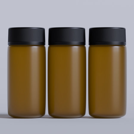Mockup of three brown plastic medicine bottles isolated on grey backgroundの写真素材