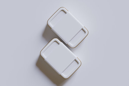 3d rendering of two square white ceramic plates on a gray backgroundの写真素材