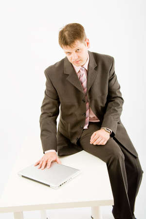 Young business man with laptop computer on white backgroundの写真素材