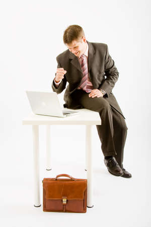 Young business man with laptop computer on white backgroundの写真素材