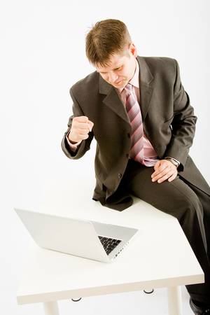 Young business man with laptop computer on white backgroundの写真素材