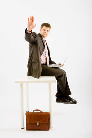 Young business man with laptop computer on white backgroundの写真素材