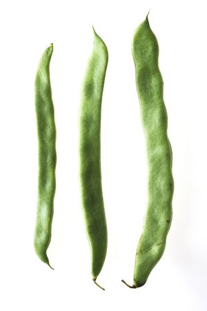 three pods of french beans on white background