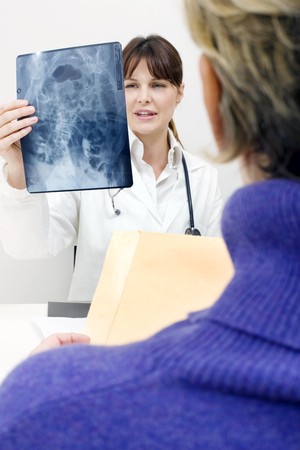 patient and female doctor examining an X-ray