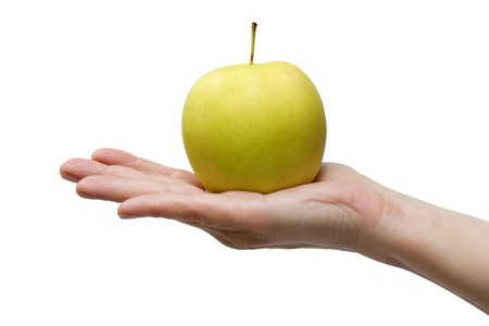 one yellow apple in the handの写真素材