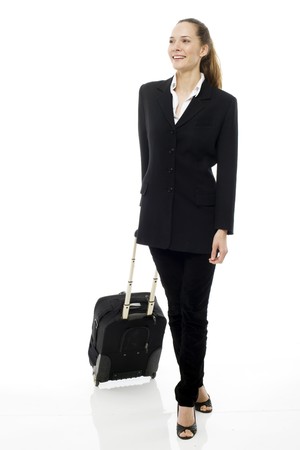 Young businesswoman with trolley on white background studioの写真素材