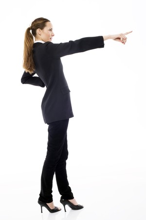 Young businesswoman standing with her hand indicating on white backgroundの写真素材