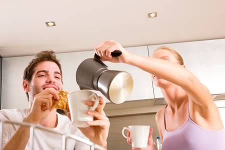 couple in kitchen having breakfastの写真素材