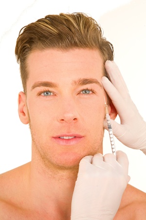 young man doing botox injectionsの写真素材