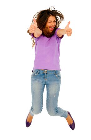 teenage girl with thumbs up jumpingの写真素材