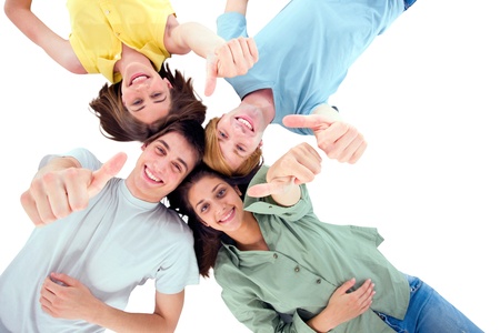 teenagers lying down with thumbs upの写真素材