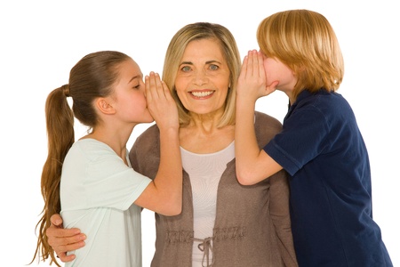 young grandmother with nephew and niece standing on white backgroundの写真素材