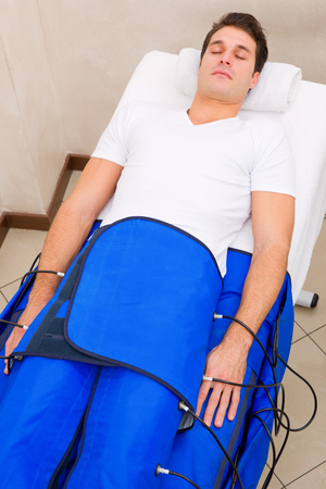 legs pressotherapy machine on man in beauty centerの写真素材