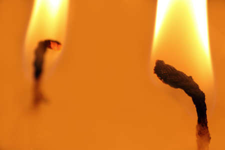 Two fires in close-up in the orange lightの写真素材