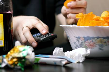 fat man watching TVの写真素材