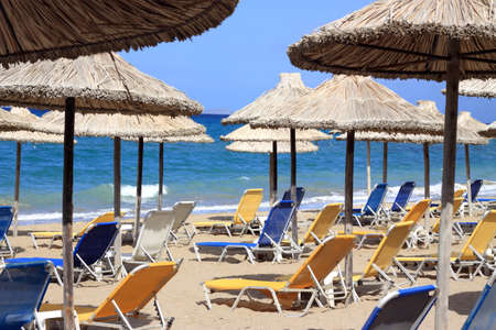 Empty chairs and umbrellas on the beachのeditorial素材