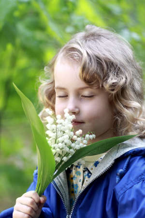 Lovely girl smell the flowersの写真素材